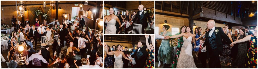Snohomish Wedding Photographer GSquared Weddings A joyous wedding celebration in a wooden hall. The bride and groom dance energetically with guests forming a circle around them. The room is decorated with flowers and lit chandeliers, creating a festive atmosphere. Serving Seattle, Snohomish and Washington State