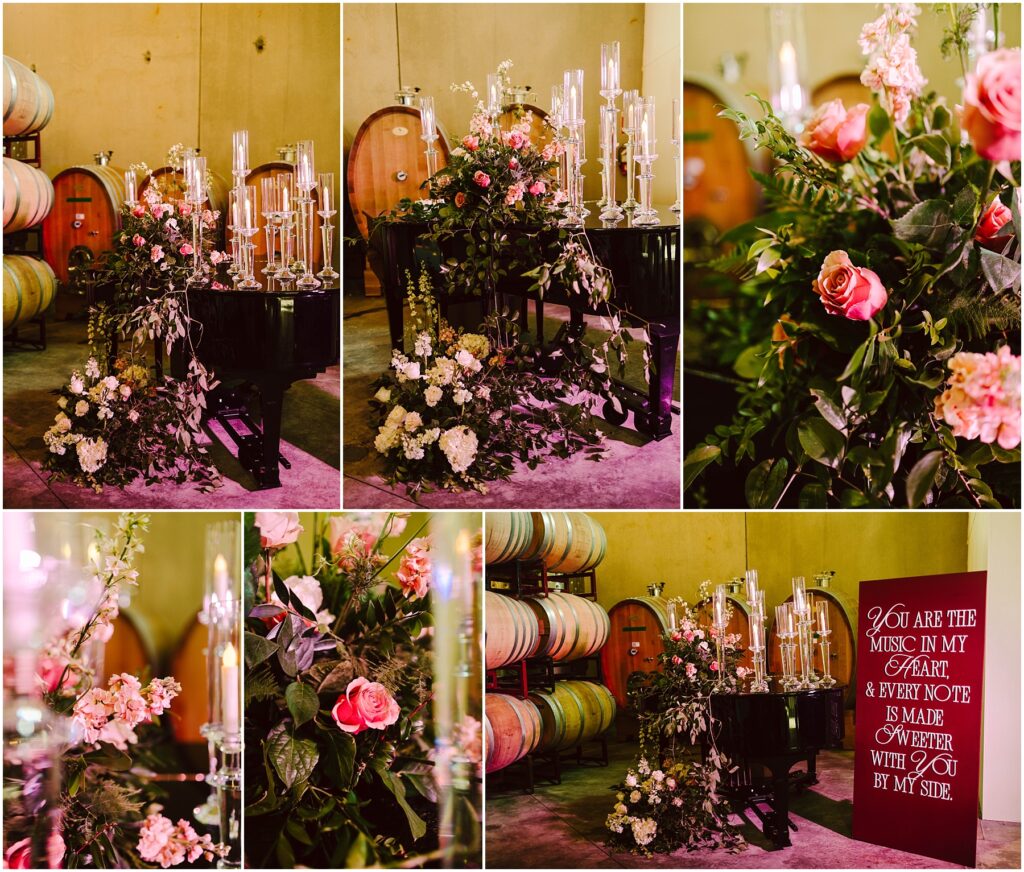 Snohomish Wedding Photographer GSquared Weddings A grand piano is adorned with floral arrangements featuring pink, white, and cream flowers. Candle holders are placed on and around the piano. Wine barrels are visible in the background. A sign reads, You are the music in my heart & every note is made sweeter with you by my side. Serving Seattle, Snohomish and Washington State