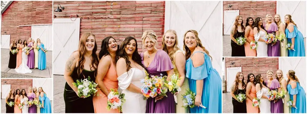 Snohomish Wedding Photographer GSquared Weddings A group of six smiling women stand in front of a charming Machias barn, its rustic red facade adorned with white doors. They wear colorful, elegant dresses and hold vibrant floral bouquets, creating a joyful and celebratory scene. Serving Seattle, Snohomish and Washington State