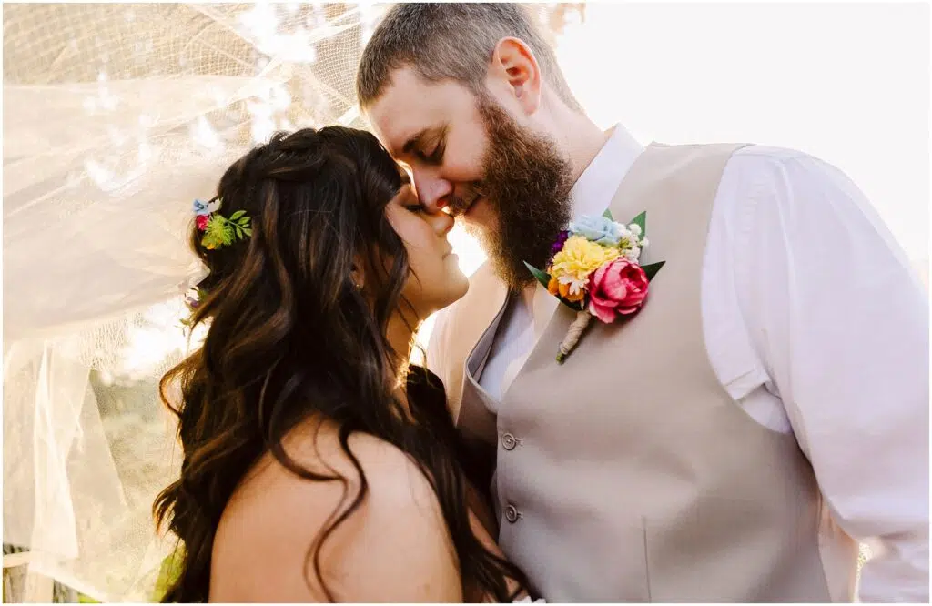 Snohomish Wedding Photographer GSquared Weddings A couple stands embracing their foreheads touching and eyes closed The woman adorned with floral accessories and the bearded man in a vest with a flower boutonniere share a serene moment bathed in the soft sunlight of Machias Serving Seattle Snohomish and Washington State Snohomish Wedding Photographer GSquared Weddings A couple stands embracing, their foreheads touching and eyes closed. The woman, adorned with floral accessories, and the bearded man in a vest with a flower boutonniere, share a serene moment bathed in the soft sunlight of Machias. Serving Seattle, Snohomish and Washington State