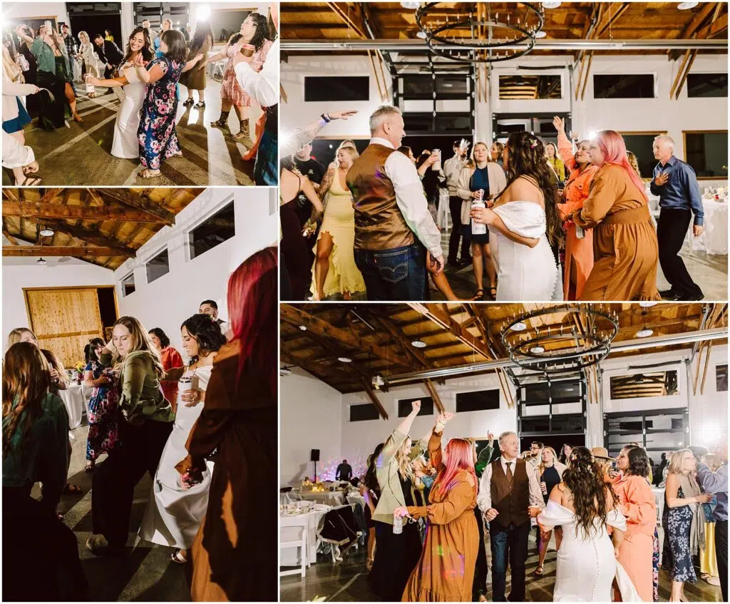 Snohomish Wedding Photographer GSquared Weddings Guests joyfully dance at a lively indoor wedding reception in Machias. They are in a spacious venue with wooden ceilings and modern chandeliers. People display a range of colorful outfits, adding to the festive atmosphere. Serving Seattle, Snohomish and Washington State