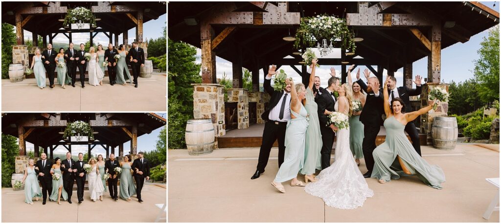 Snohomish Wedding Photographer GSquared Weddings A wedding party poses joyfully in front of a wooden pavilion at the winery. The bride in a white dress is surrounded by bridesmaids in sage green and groomsmen in black suits. Everyone raises their arms in celebration against a lush backdrop of greenery. Serving Seattle, Snohomish and Washington State