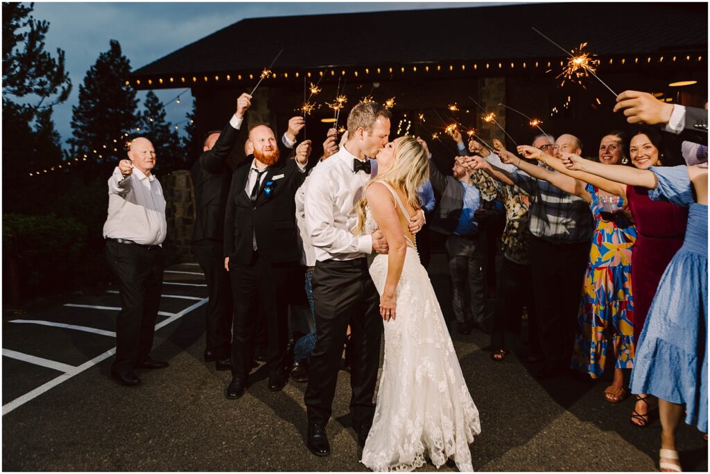 Snohomish wedding photographer gsquared weddings a newlywed couple shares a kiss amid cheering guests holding sparklers at a charming winery The bride dazzles in a white lace gown the groom in a black suit The scene is festive set against the soft glow of twinkling string lights and lush vineyard rows Serving seattle snohomish and washington state Snohomish wedding photographer gsquared weddings a newlywed couple shares a kiss amid cheering guests holding sparklers at a charming winery The bride dazzles in a white lace gown the groom in a black suit The scene is festive set against the soft glow of twinkling string lights and lush vineyard rows Serving seattle snohomish and washington state