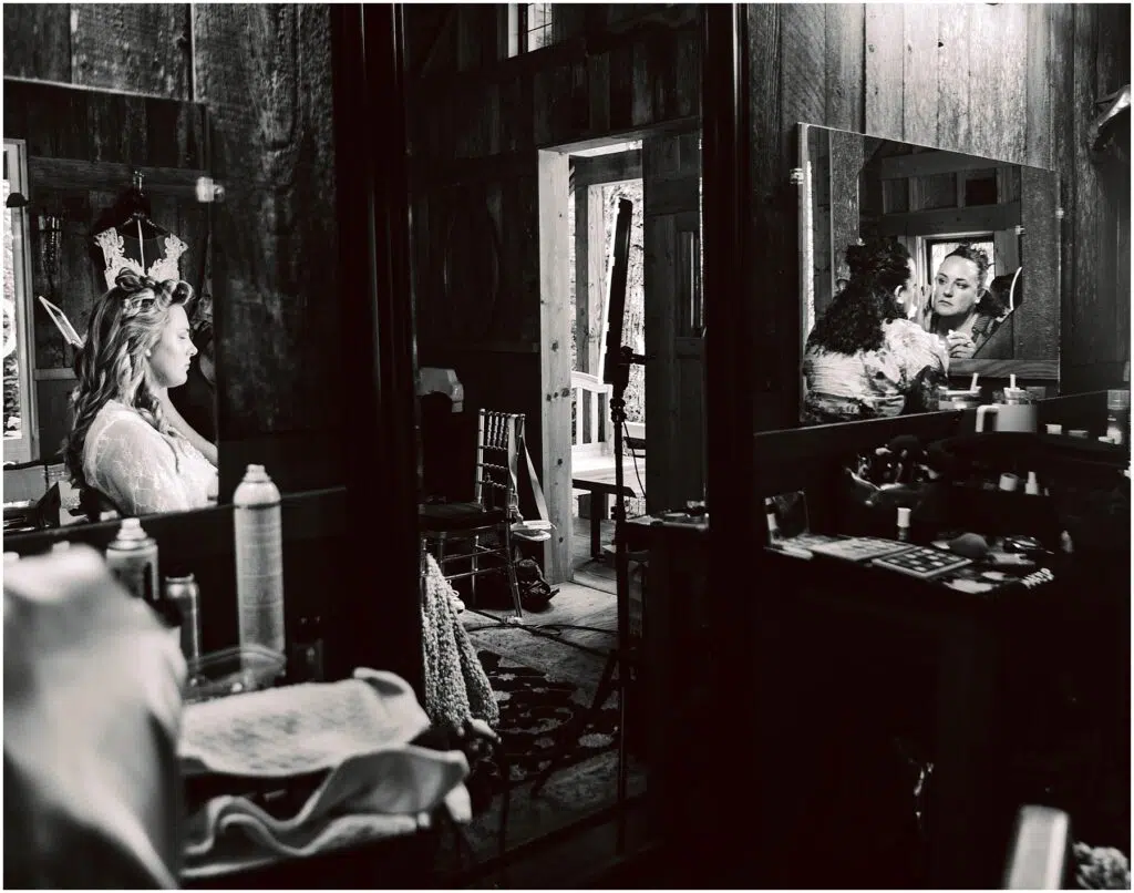 Snohomish Wedding Photographer GSquared Weddings In a rustic Snohomish room a bride sits before a mirror preparing for her wedding The reflection shows her smiling face amid wedding essentials An open door leads outside as natural light filters through the space Black and white photo Serving Seattle Snohomish and Washington State Snohomish Wedding Photographer GSquared Weddings In a rustic Snohomish room, a bride sits before a mirror, preparing for her wedding. The reflection shows her smiling face amid wedding essentials. An open door leads outside as natural light filters through the space. Black and white photo. Serving Seattle, Snohomish and Washington State
