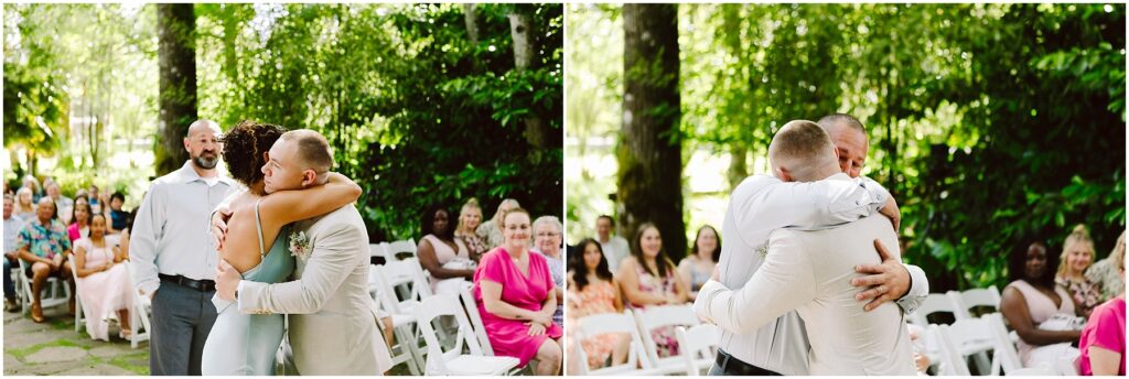 Snohomish Wedding Photographer GSquared Weddings Two people embrace in a heartfelt hug amidst the lush green landscapes of Snohomish surrounded by wedding guests seated outdoors Another person looks on with a gentle smile Serving Seattle Snohomish and Washington State Snohomish Wedding Photographer GSquared Weddings Two people embrace in a heartfelt hug amidst the lush, green landscapes of Snohomish, surrounded by wedding guests seated outdoors. Another person looks on with a gentle smile. Serving Seattle, Snohomish and Washington State