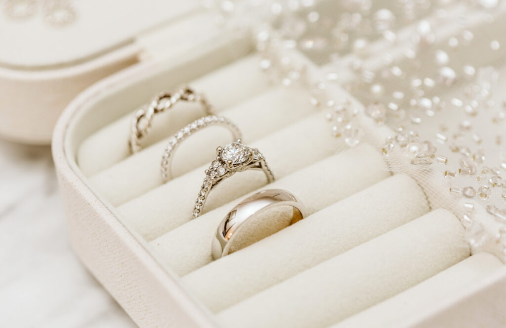 GSquared Weddings Photography Three elegant rings including a diamond engagement ring and two wedding bands are displayed in a creamcolored velvet jewelry box with delicate beads scattered nearby For wedding inquiries please reach out via GSquared Weddings contact GSquared Weddings | | Serving Snohomish Seattle Beyond GSquared Weddings Photography Three elegant rings, including a diamond engagement ring and two wedding bands, are displayed in a cream-colored velvet jewelry box with delicate beads scattered nearby. For wedding inquiries, please reach out via GSquared Weddings contact. GSquared Weddings | | Serving Snohomish, Seattle , & Beyond