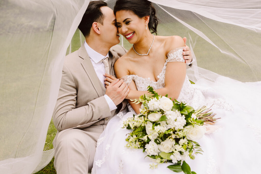Gray Bridge Sultan Snohomish Wedding GSquared Weddings Photography A bride and groom sit closely under a veil smiling and holding hands Perfect for an Elementor home page this joyful coupleshe in white with a bouquet he in a light suitradiate love and happiness ready to inspire your website builder project GSquared Weddings | | Serving Snohomish Seattle Gray Bridge Sultan Snohomish Wedding GSquared Weddings Photography