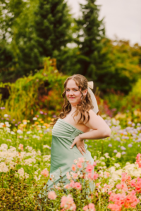 Woman in a light green strapless dress in a flower garden