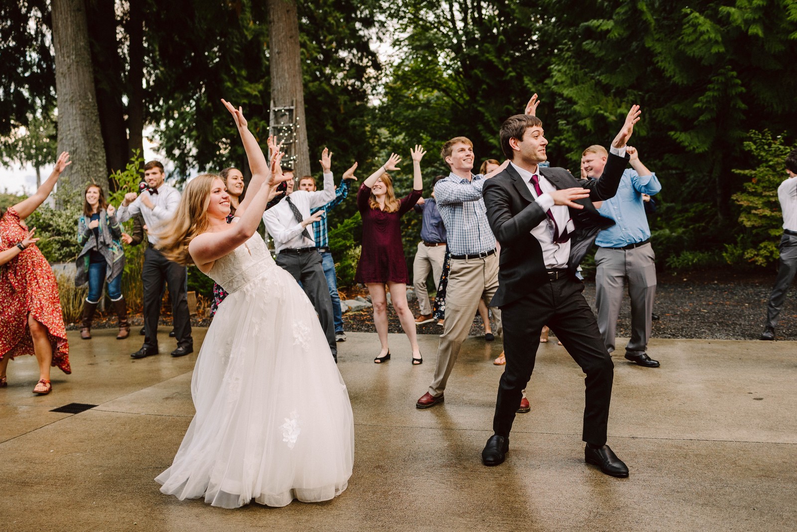 GSW13461 2 wedding couple and wedding guests dancing to michael jacksons song thriller as a group bride and groom at the front at the snohomish venue the lookout lodge intentional wedding planning and events in seattle and snohomish