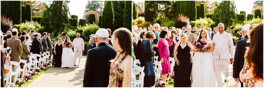 Outdoor wedding procession bride in white gown and groom in light suit walking down an aisle lined with chairs and guests holding bouquets