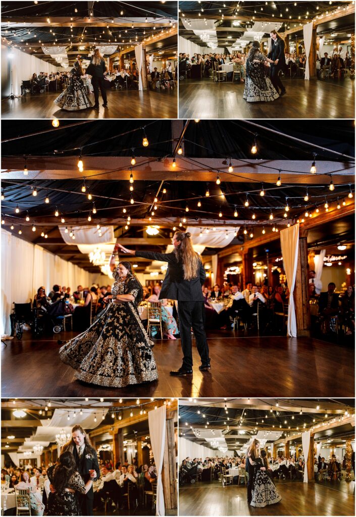 Couple dancing on a wooden floor under warm string lights at a wedding reception with guests seated at tables in the background